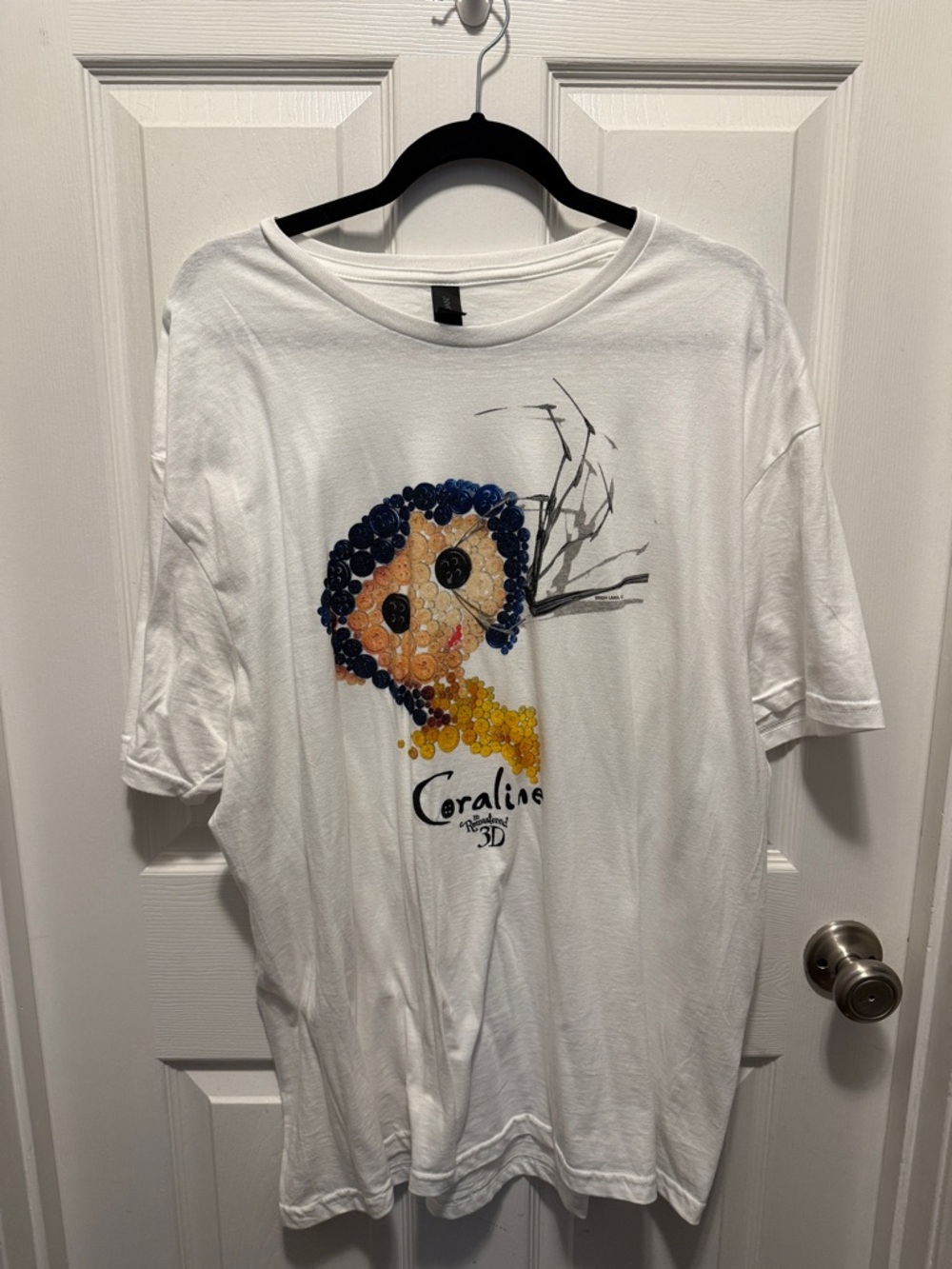White Coraline Graphic Tee with Blue & Yellow Design Regal Theatre 3D Anni